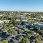 High-resolution drone shot showing ample surface parking at 9930 Irvine Center Drive creative office.