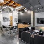 Integrated lobby lounge and kitchenette area providing a collaborative break space for employees.