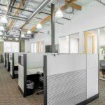 Expansive view of the second-floor creative workspace showing the open-staircase and modern office flow.