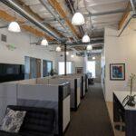 Premium **Irvine Spectrum office lease** at 9930 Irvine Center Drive featuring a turn-key creative workspace with modern workstations and open ceilings.