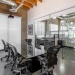 Glass-walled first-floor conference room equipped for professional meetings and presentations.