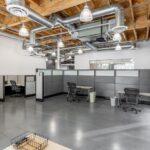 Turn-key creative office space on the first floor with modern workstations and open-plenum ceilings.