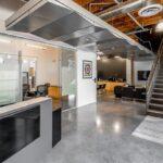 Main lobby entrance at 9930 Irvine Center Drive featuring creative open ceilings and modern flooring.